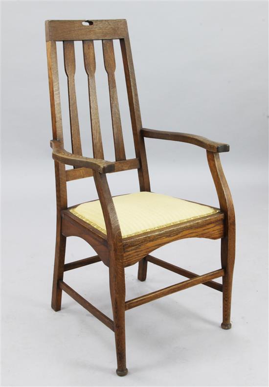 C.R. Macintosh. An Arts & Crafts oak elbow chair, H.3ft 6in.